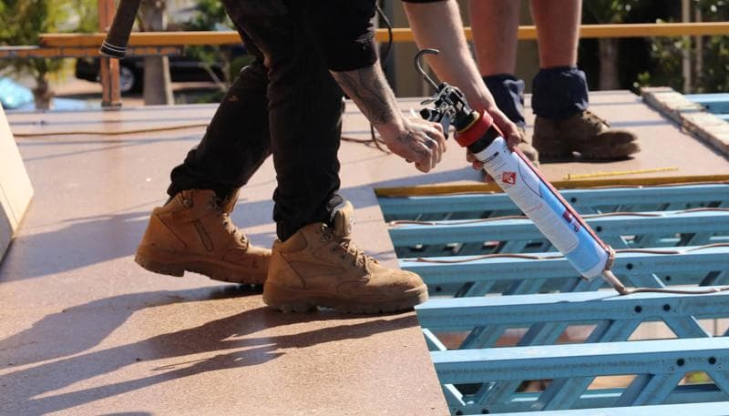 Particle board flooring laid over floor joists as a subfloor