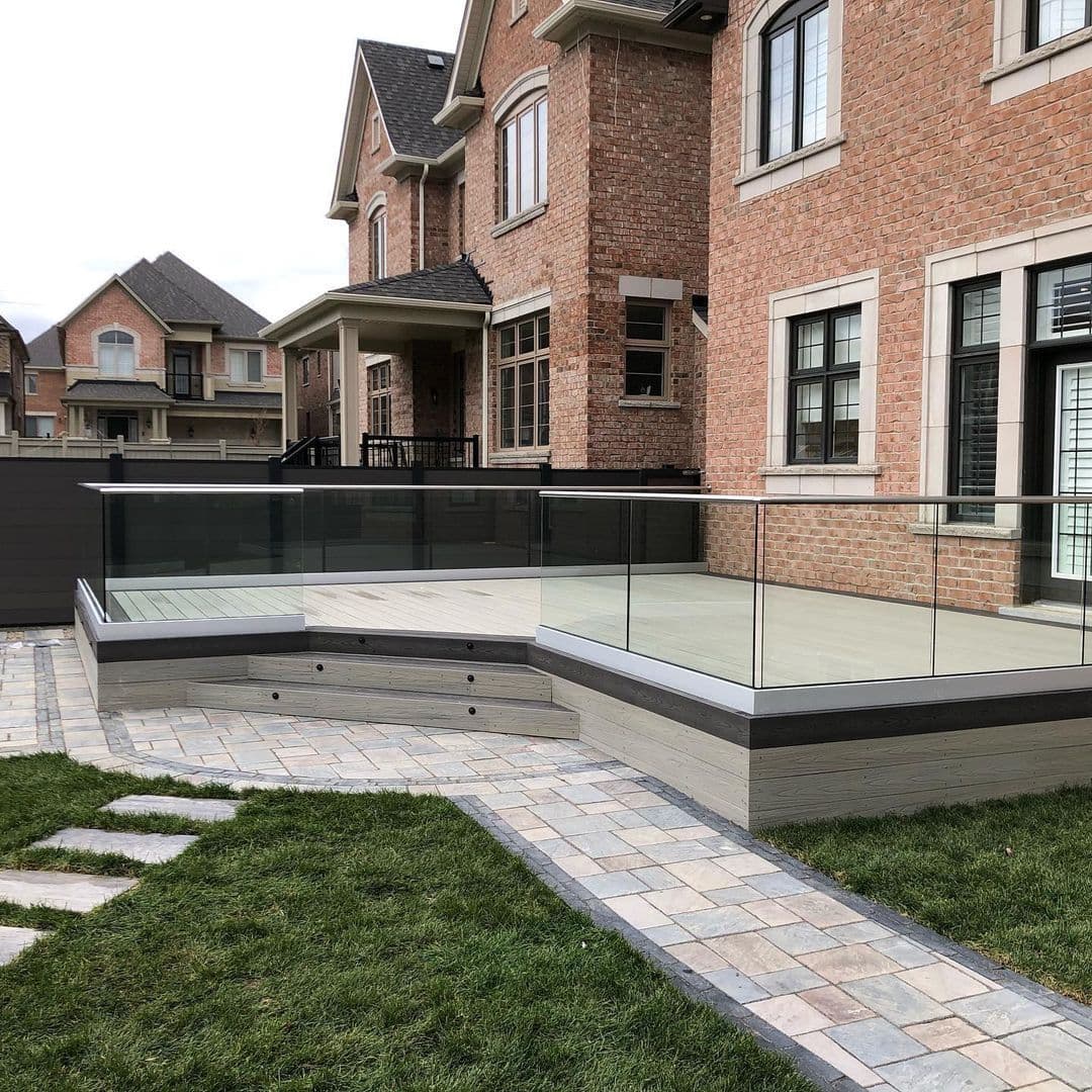 MexyTech Suprotect composite decking with a glass balustrade on a modern home