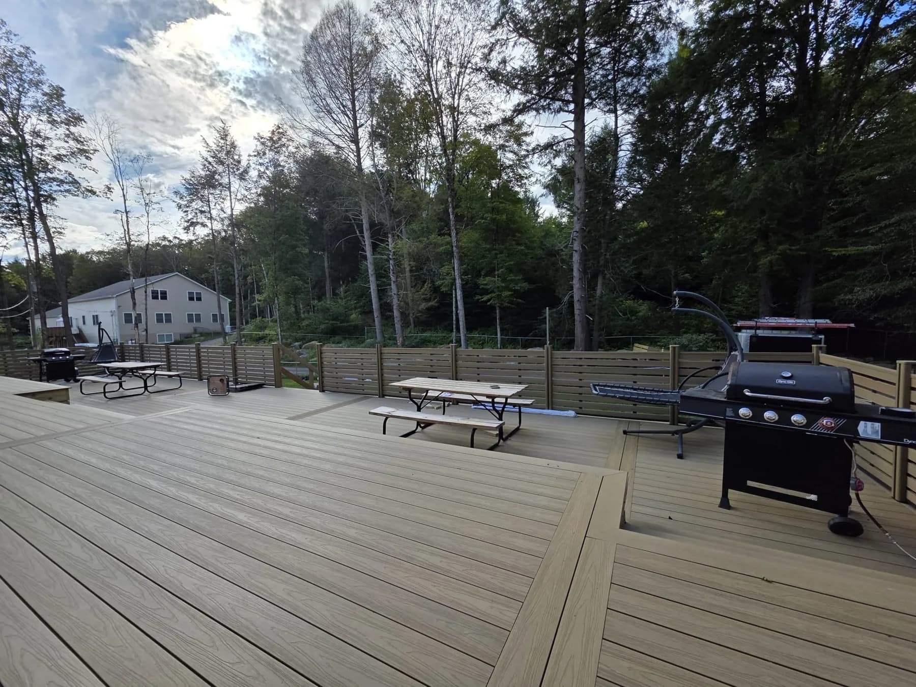 MexyTech composite decking and matching privacy screen on a backyard deck